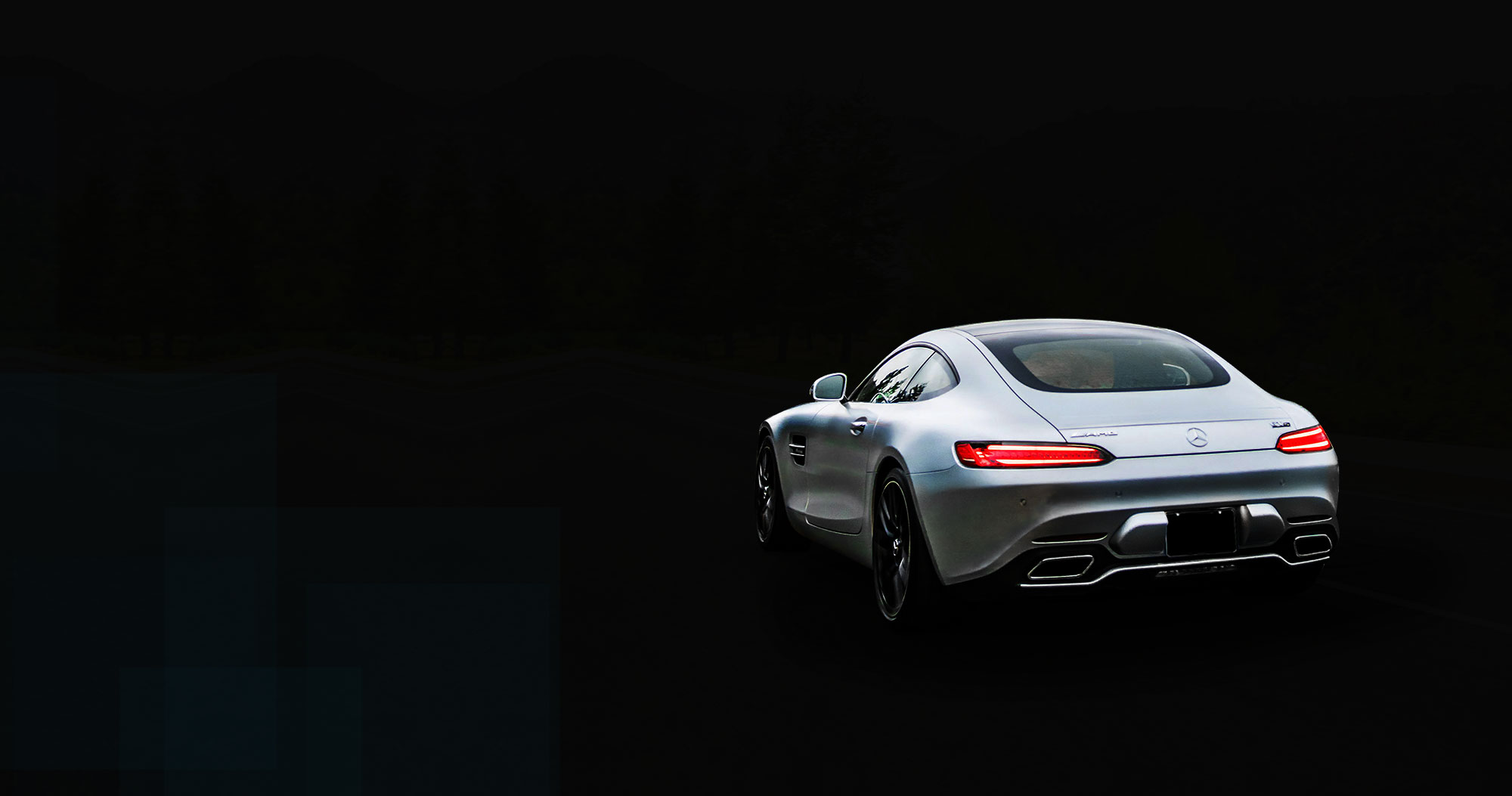 Silver sports coupe at night